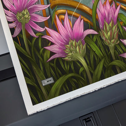 Close-up of a print with pink flowers and green leaves on a dark surface.